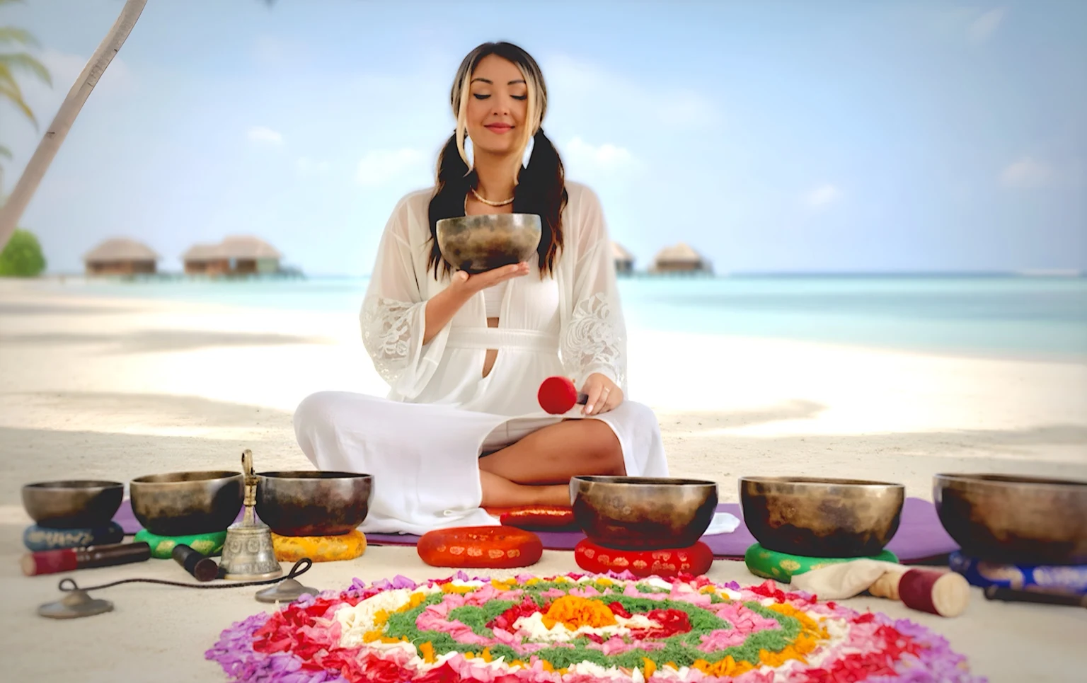 Lita with Himalayan singing bowls in the Maldives